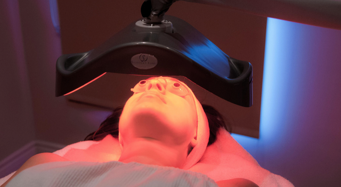 Load video: Lumifacial cold laser is been performed on woman laying down, while massaging it on your skin.